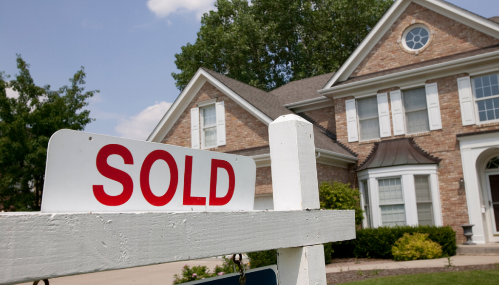 Sold sign in front of house. Real Estate in Germantown, WI | House to Home Realty Team