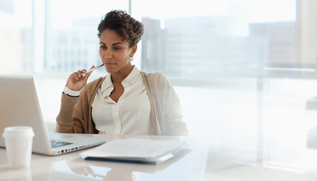 Businesswoman using laptop in office